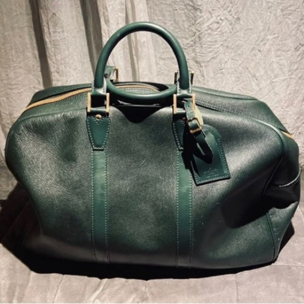 Louis Vuitton green Kendall Taiga duffel bag.